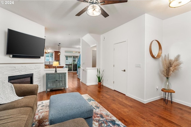 living room with ceiling fan, a fireplace, and hardwood / wood-style flooring