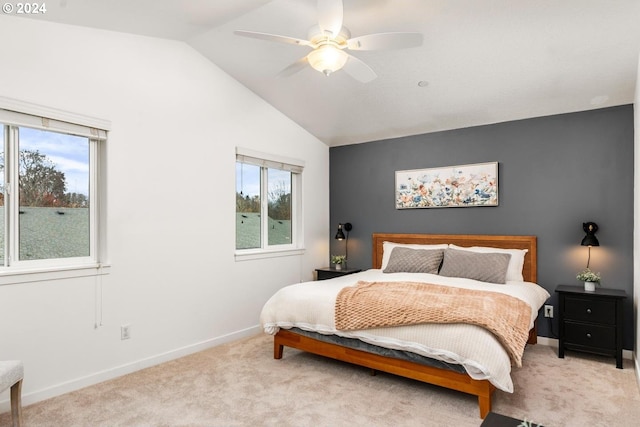 carpeted bedroom with vaulted ceiling and ceiling fan