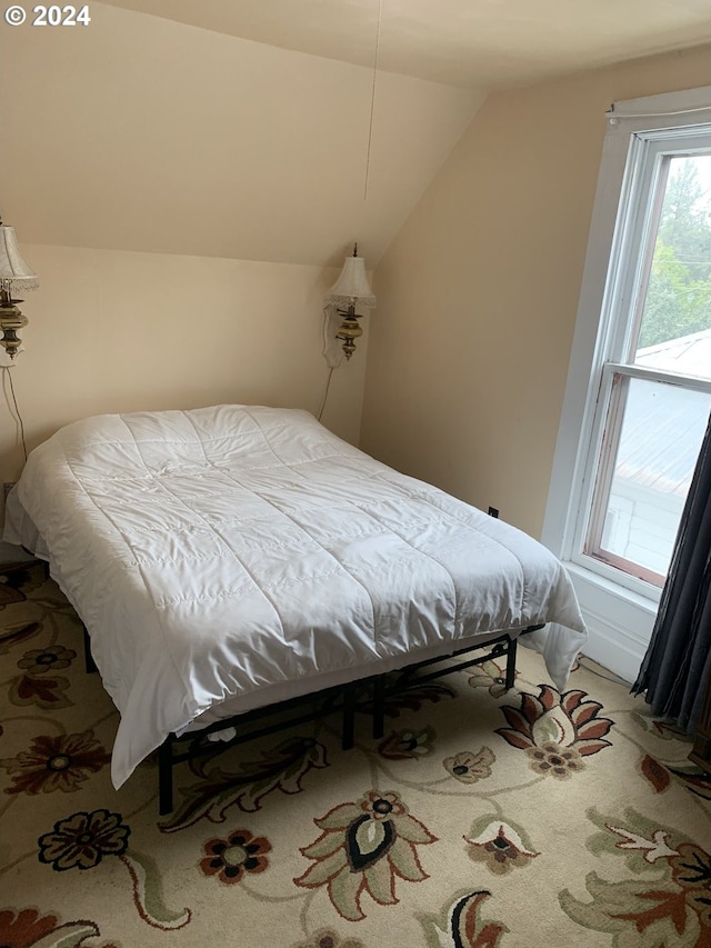 bedroom featuring vaulted ceiling and carpet floors