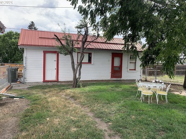 rear view of property with a lawn