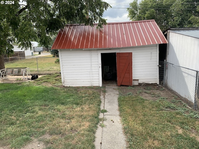 view of outbuilding with a yard