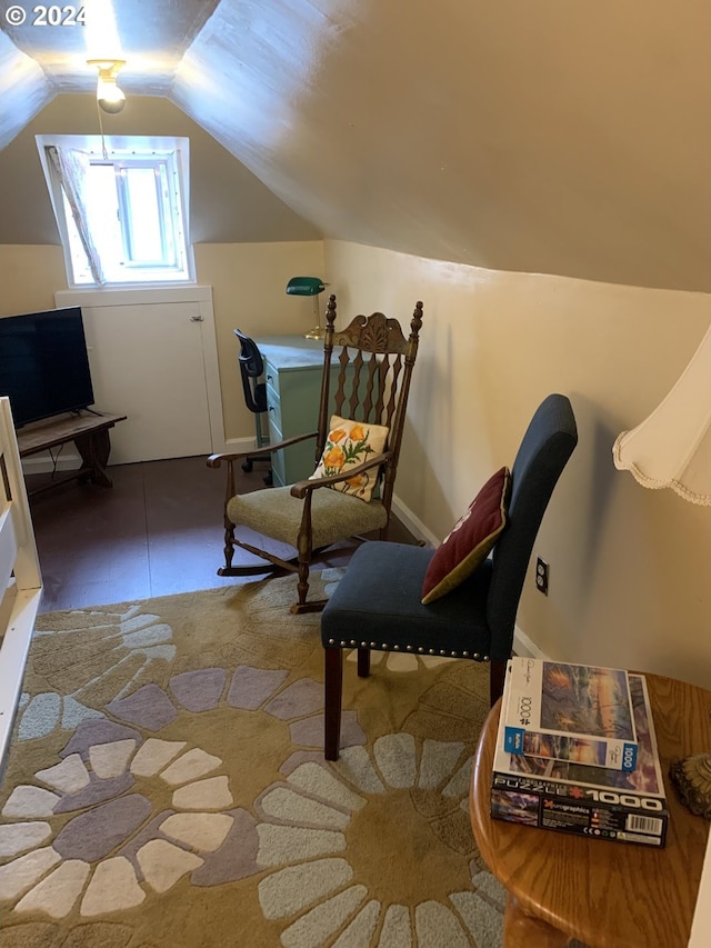 sitting room with vaulted ceiling