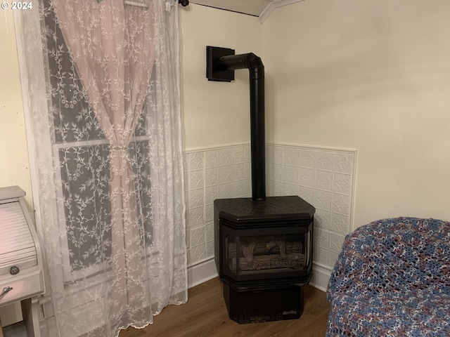 interior details featuring hardwood / wood-style flooring and a wood stove