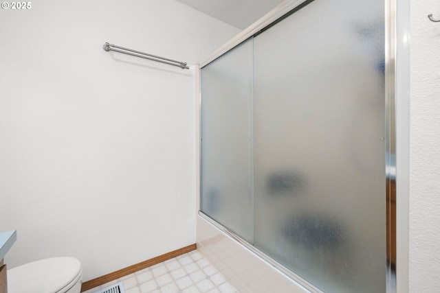 full bath featuring vanity, tile patterned floors, toilet, combined bath / shower with glass door, and baseboards