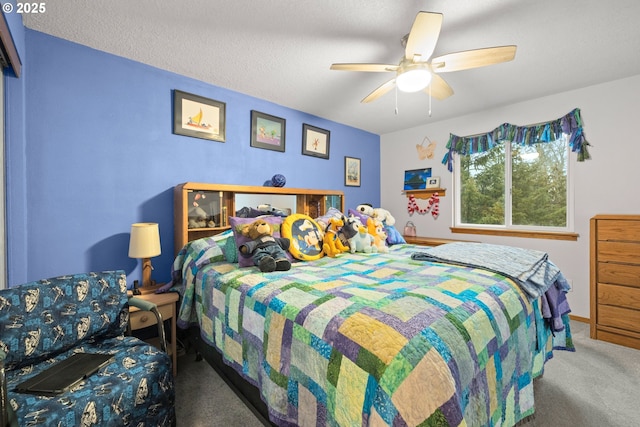 carpeted bedroom with ceiling fan and a textured ceiling