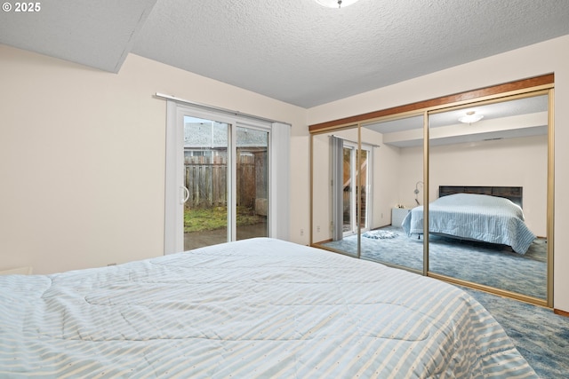 bedroom featuring a textured ceiling, a closet, carpet, and access to exterior