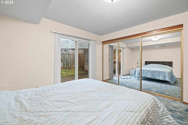carpeted bedroom with access to exterior, a textured ceiling, and a closet