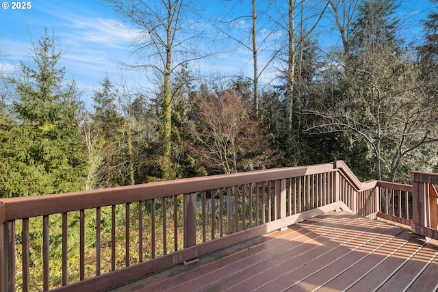 wooden terrace with a view of trees