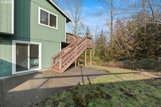 exterior space featuring a patio area, a yard, stairway, and a wooden deck