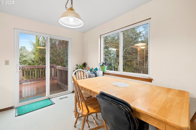 dining room featuring carpet floors, baseboards, and visible vents