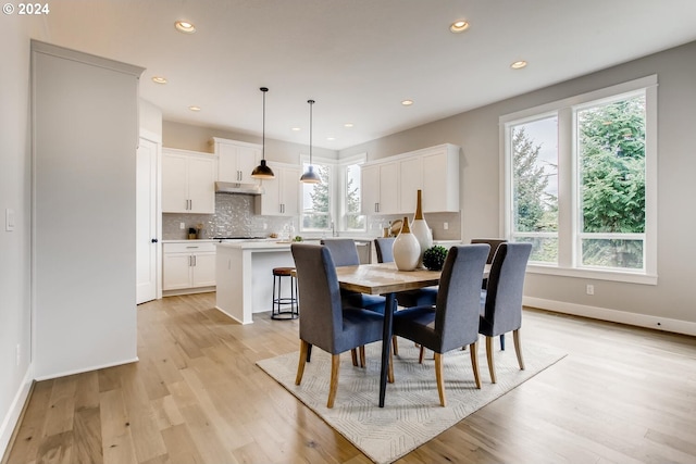 dining space with light hardwood / wood-style flooring and plenty of natural light