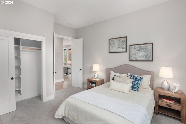 bedroom featuring light carpet and a closet