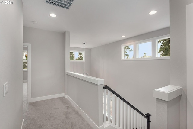 hall with light carpet and plenty of natural light