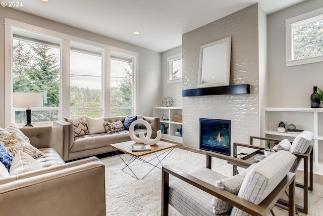 living room featuring a fireplace, hardwood / wood-style flooring, and plenty of natural light