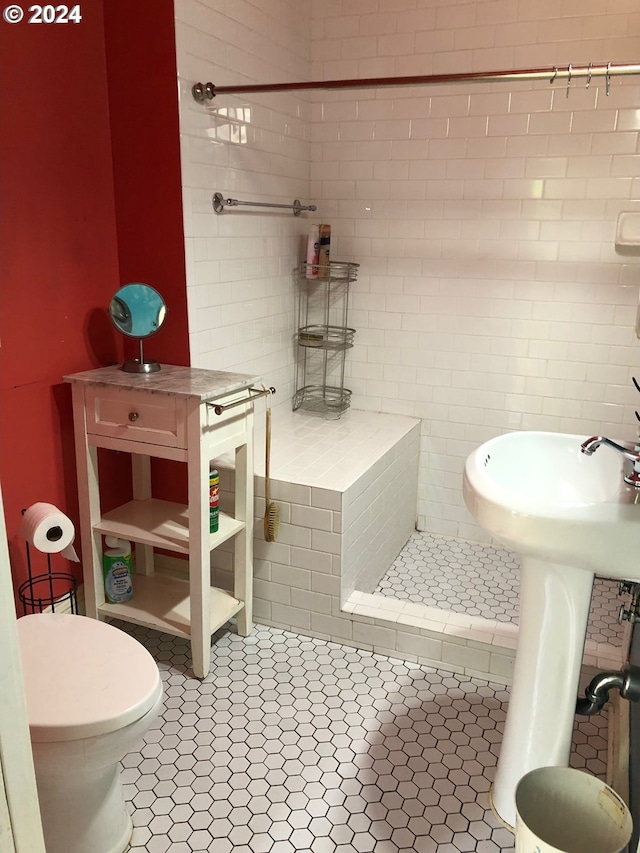 full bath with a sink, tile patterned flooring, toilet, and a shower stall