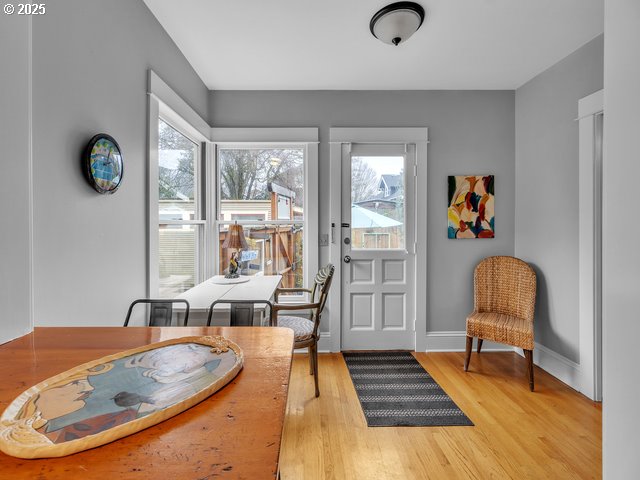 dining space with baseboards and wood finished floors