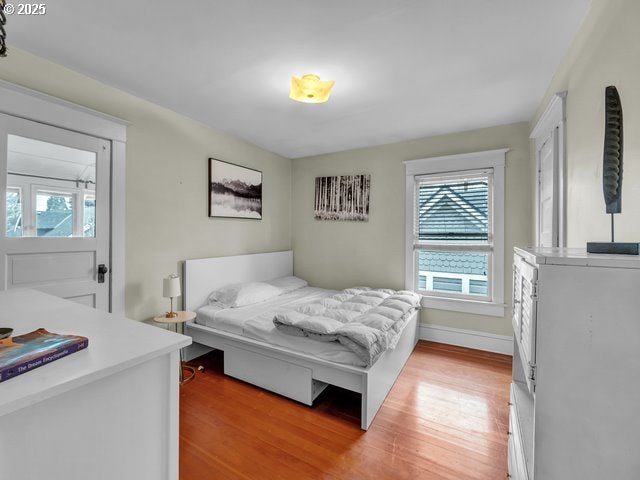 bedroom featuring light wood-type flooring and baseboards