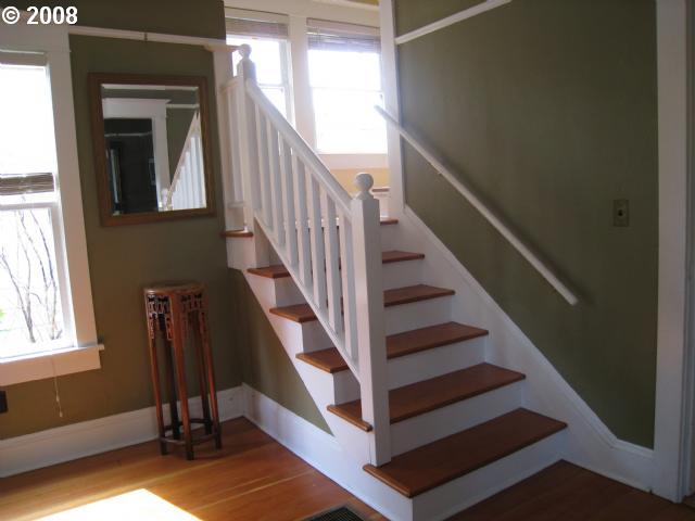 stairs with baseboards, wood finished floors, and a healthy amount of sunlight