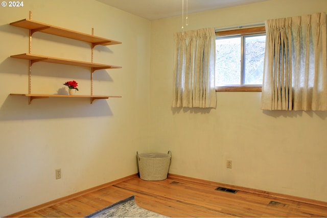 spare room with hardwood / wood-style flooring