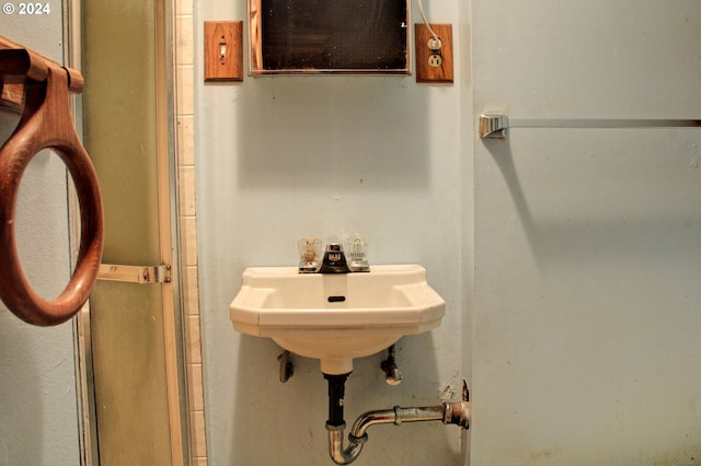 bathroom featuring a shower with door