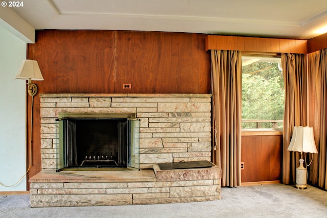 details with carpet flooring, a fireplace, and wooden walls