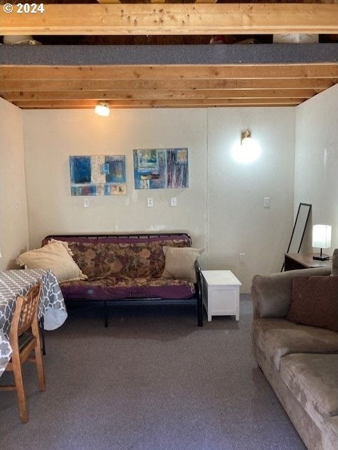 living room with beamed ceiling and carpet flooring