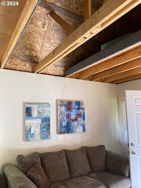 living room featuring lofted ceiling with beams