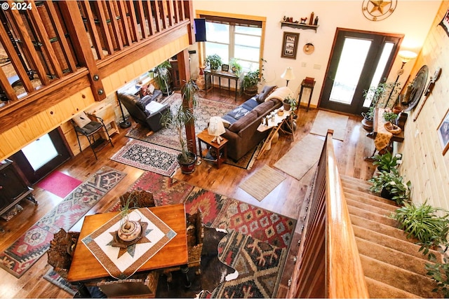 living room with hardwood / wood-style flooring, a high ceiling, and french doors