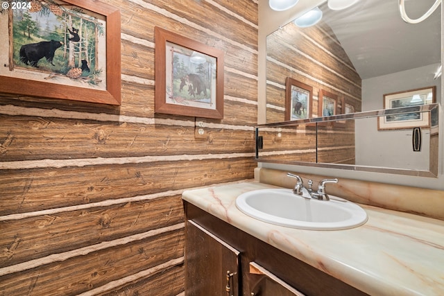 bathroom with wood walls and vanity