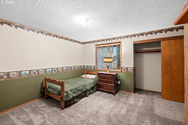 bedroom featuring a textured ceiling, carpet floors, and a closet