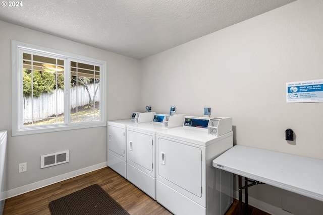 laundry room featuring dark hardwood / wood-style flooring, a textured ceiling, and independent washer and dryer