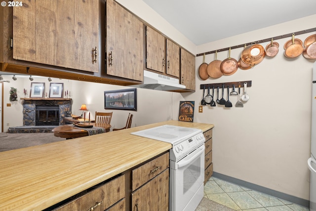 kitchen featuring a fireplace, light tile patterned flooring, and electric stove