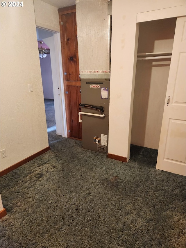 unfurnished bedroom featuring a closet and dark colored carpet