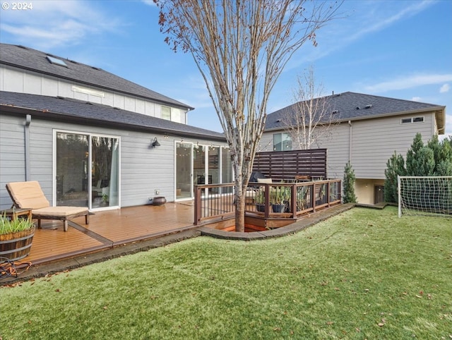 back of house featuring a yard and a wooden deck