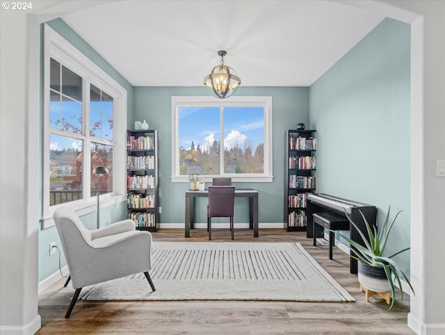 living area with a chandelier and hardwood / wood-style flooring