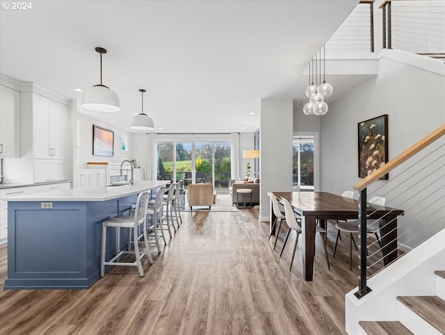 dining space with hardwood / wood-style floors and sink