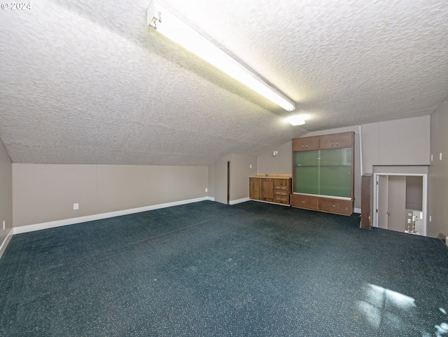 bonus room featuring a textured ceiling and vaulted ceiling