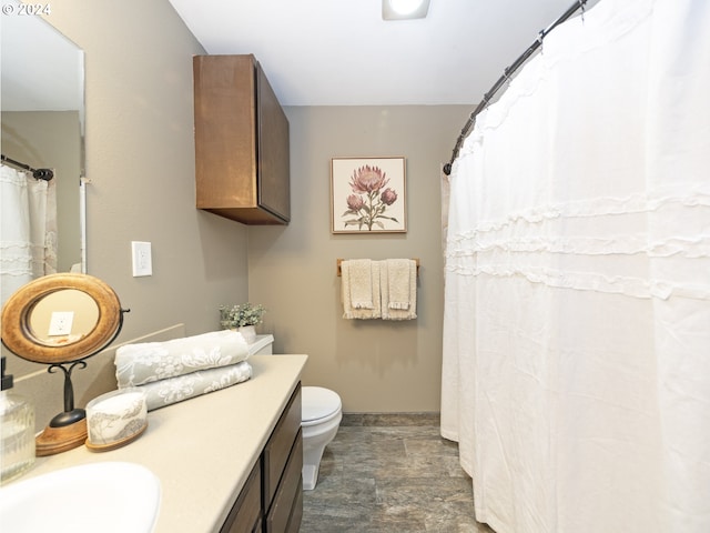 bathroom featuring vanity and toilet