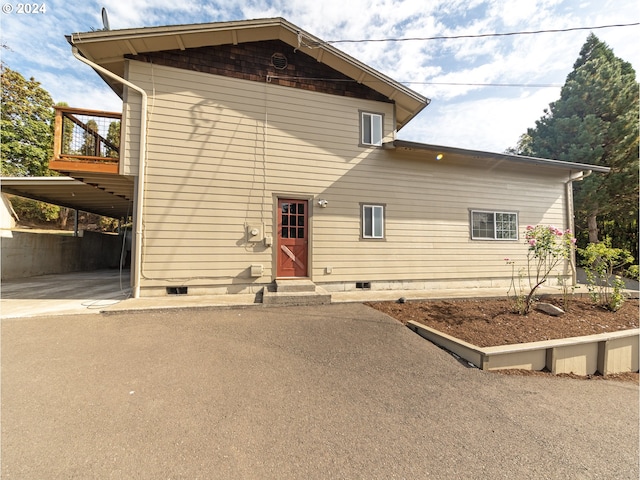 back of property featuring a carport