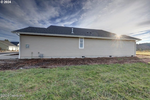 view of side of home featuring a yard