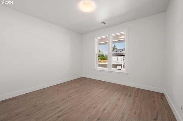 spare room with hardwood / wood-style flooring