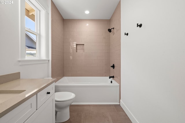 full bathroom featuring vanity, tiled shower / bath, tile patterned flooring, and toilet