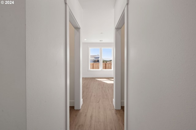 corridor with light hardwood / wood-style flooring