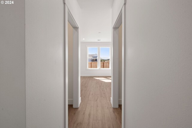 hall with light hardwood / wood-style flooring