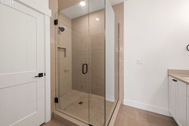 bathroom featuring vanity and a shower with shower door