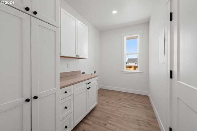 interior space with white cabinetry and light hardwood / wood-style floors