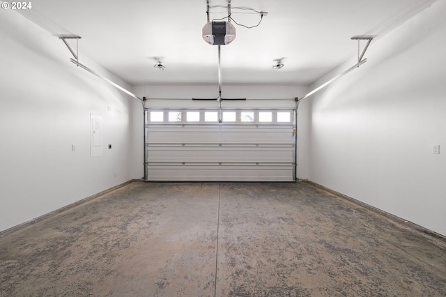 garage with a garage door opener and electric panel