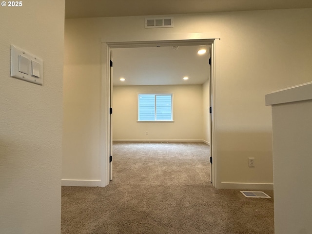 hall featuring light carpet