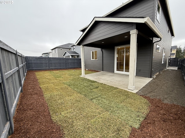 back of house featuring a patio area and a lawn