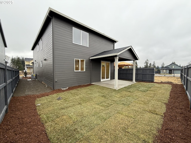 rear view of property with a patio and a lawn